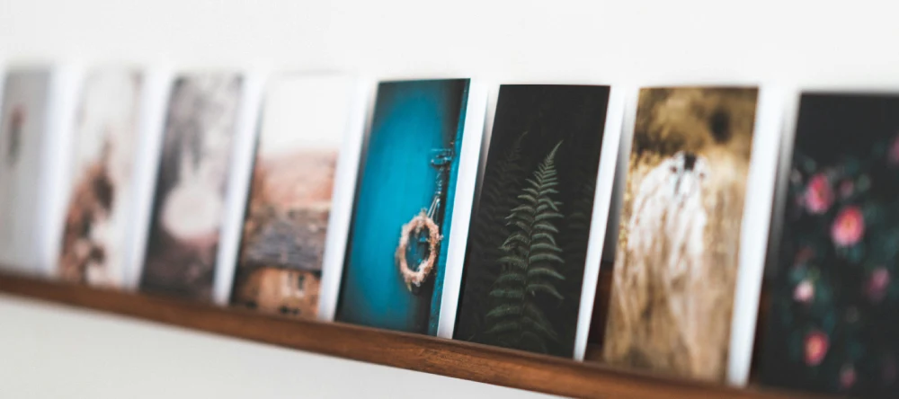 photo prints decorating a wall shelf