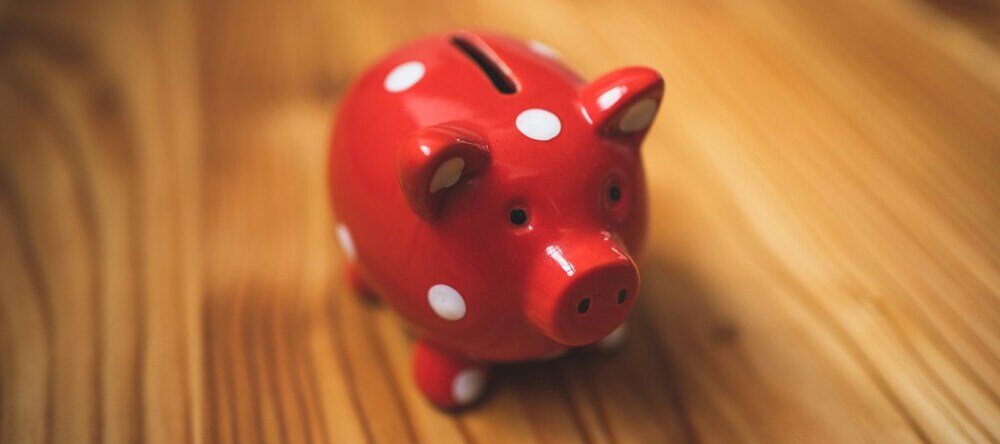 Canvas Printing Near Me. Red spotted piggy bank on wooden surface.
