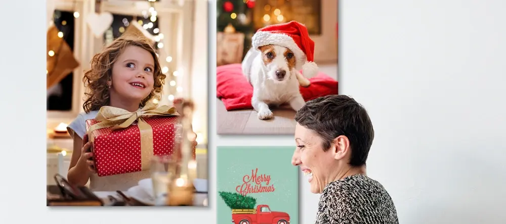 Christmas canvas wall art: a woman hanging canvas prints on the wall