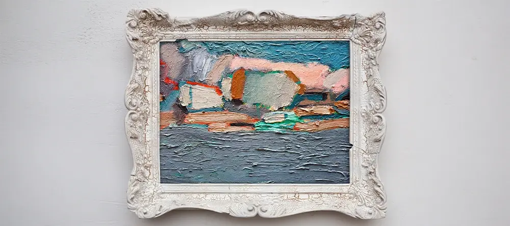 A canvas being framed on a table