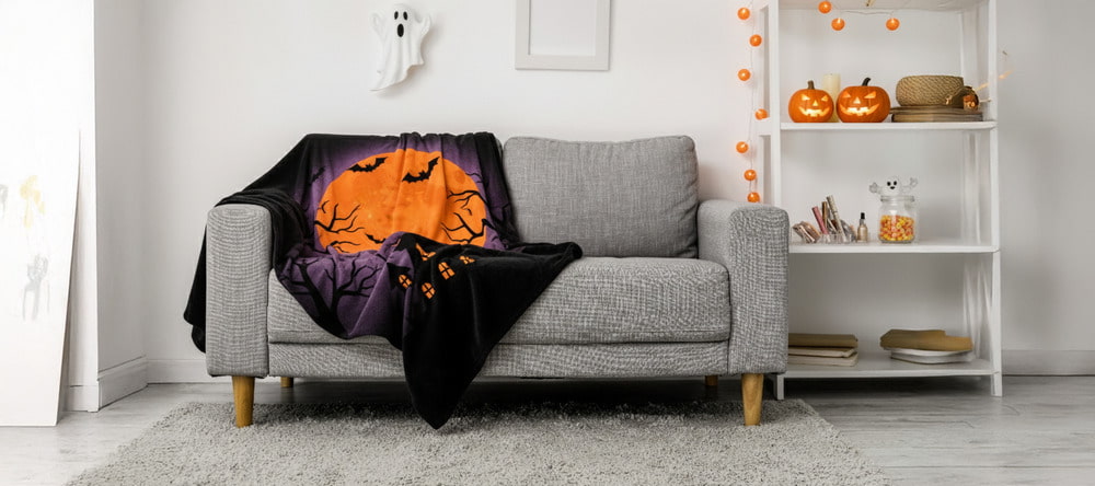 How to Make Personalized Halloween Gifts. Blanket with Halloween print on couch.