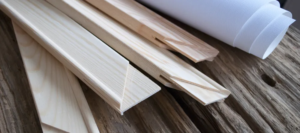 How much does it cost to make a canvas print. Stretcher bars and canvas on wooden table.