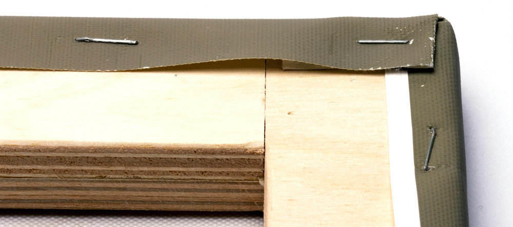 Do cheap canvas prints mean bad canvas prints. Wooden canvas edge close-up with staples.