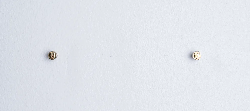 How to hang canvas prints. Two nails hammered into wall for hanging pictures.