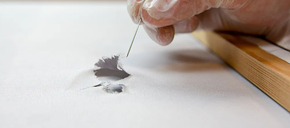 How to fix a ripped canvas. Arranging threads around tear on canvas. 