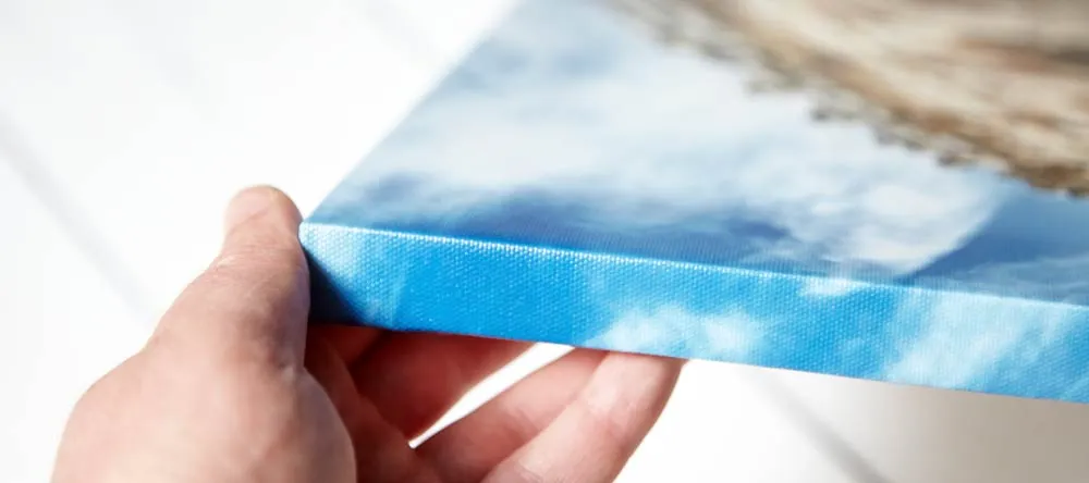 Custom-Made Canvases: 10 Myths Debunked. Close-up of person examining gallery-wrapped canvas.