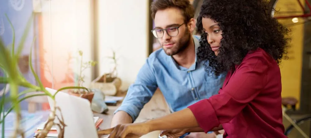 10 Common Myths About Personalized Canvas Prints: Part II. Young couple browsing for online canvas printing services.