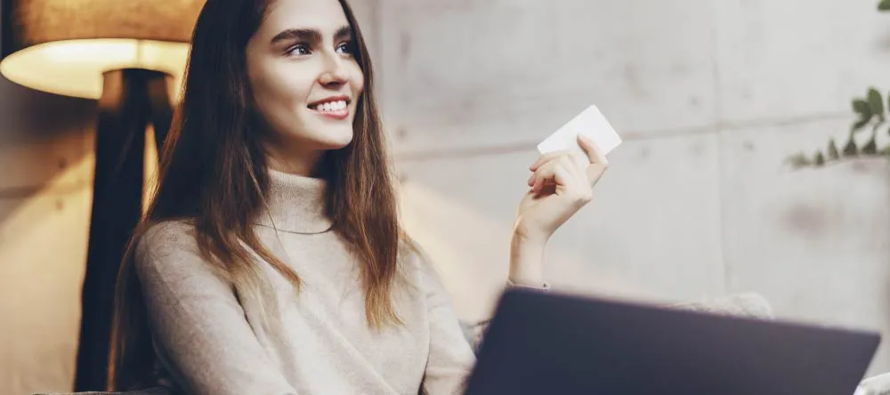 What is the Best Place to Get Canvas Prints on a Budget? Young woman looking for canvas printing service online.