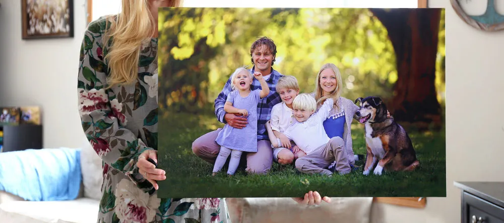 What is a canvas print. Woman holding family photo canvas print.