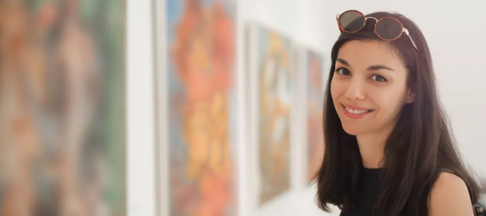 Why Should I Buy Canvas Prints. Smiling Woman in a Gallery.