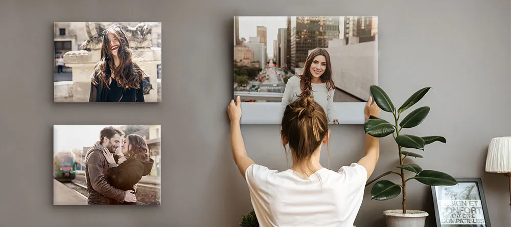 Trendy Canvas Wall Art: a woman hanging canvas prints on the wall