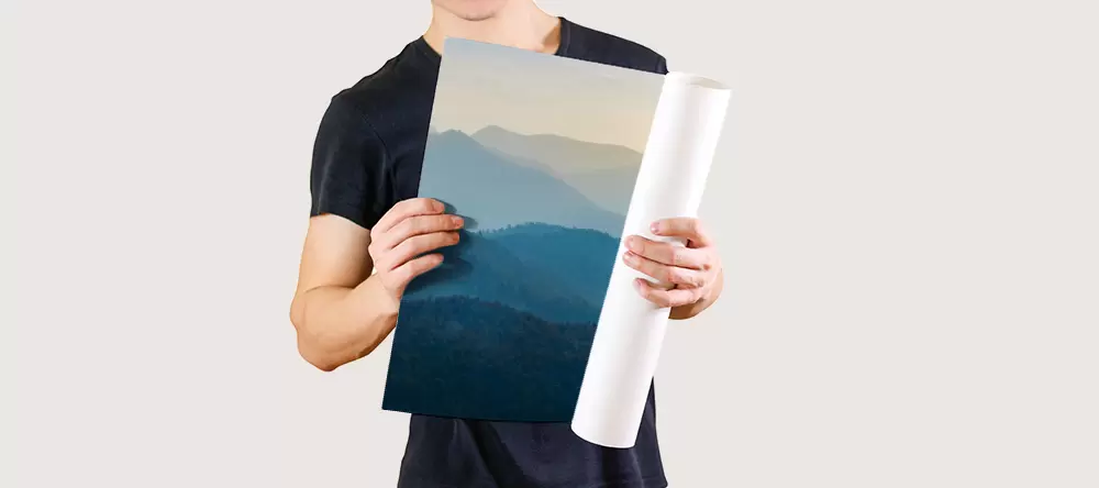 How to Hang a Poster: a man holding a rolled poster print