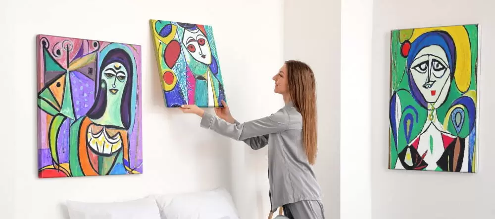 Abstract art on canvas: woman hanging an abstract art print on the wall