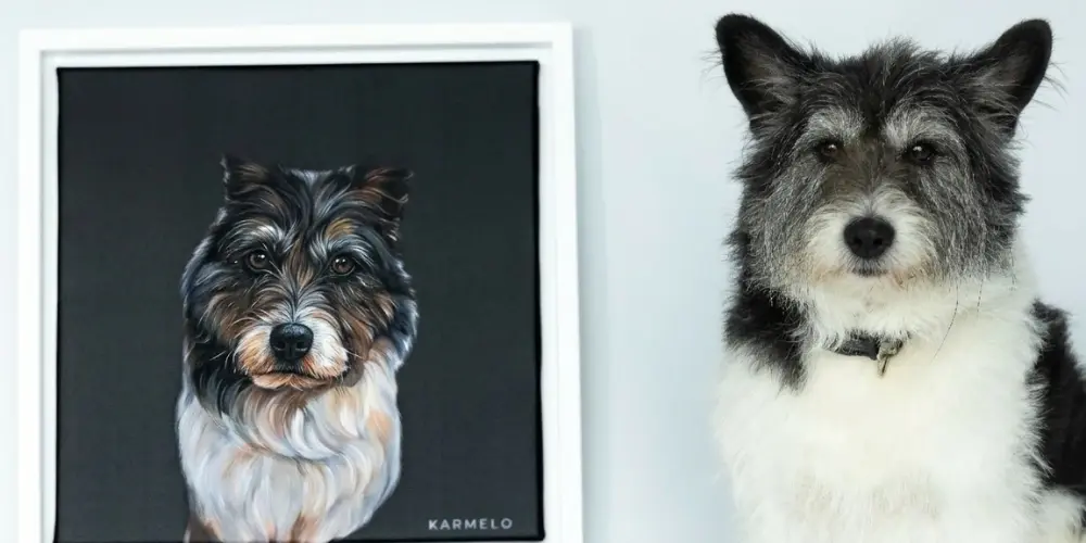 Dog sitting next to a custom framed portrait on a living room wall
