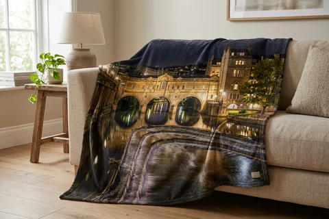 photo blanket bath – a plush blanket printed edge to edge with Pulteney Bridge at night draped over a sofa