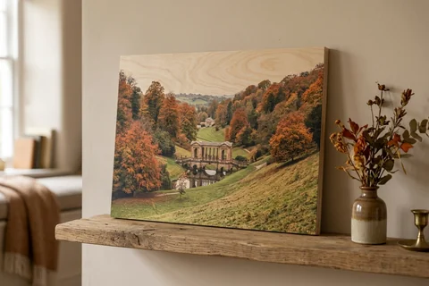 photo print on wood bath – a wood print of Prior Park in autumn with the grain visible through the image, leaning on a shelf