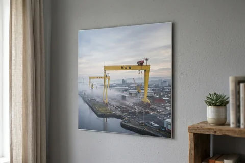 aluminium photo print belfast – a matte aluminium panel print of the Harland and Wolff cranes in morning mist mounted flush on a grey wall