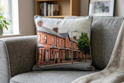 photo cushion belfast – a plush square cushion printed borderless with a red-brick Stranmillis terrace on a grey sofa