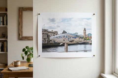 poster print belfast – an unframed poster print of the Big Fish on Donegall Quay pinned to a pale wall