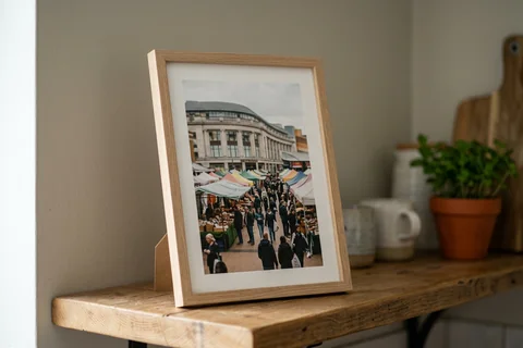 framed photo board birmingham – a slim-framed photo board of the Bull Ring markets standing on a kitchen shelf