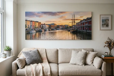 panoramic canvas print bristol – a wide panoramic canvas of the Floating Harbour at sunset hung above a long sofa