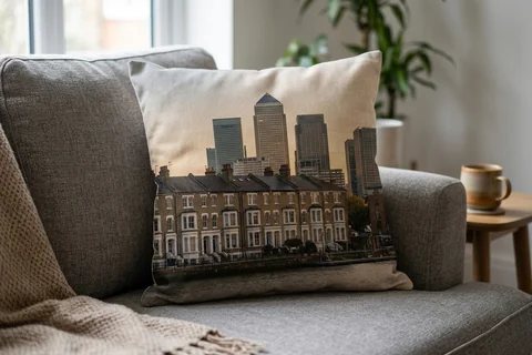 photo cushion canary wharf – a plush square cushion printed borderless with a Limehouse terrace on a grey sofa