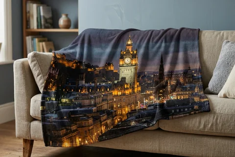 photo blanket edinburgh – a plush blanket printed edge to edge with the Balmoral clock at night draped over a sofa