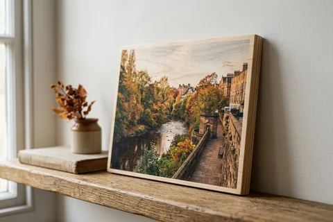 photo print on wood edinburgh – a wood print of the Water of Leith in autumn with the grain visible through the image, leaning on a shelf
