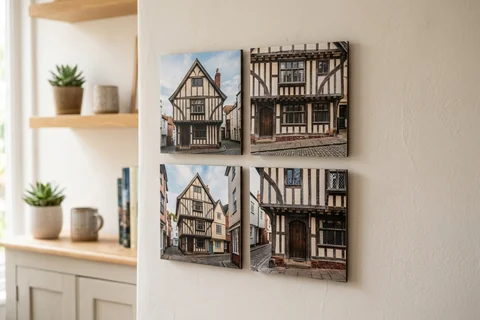 mixpix photo tiles exeter – four 20×20 cm photo tiles of the House That Moved arranged in a cluster on a white wall with no visible fixings