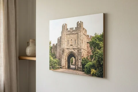 photo board print exeter – a frameless matte photo board of Rougemont Castle gatehouse hanging flush on a pale wall