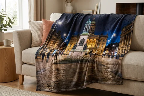 photo blanket hull – a plush blanket printed edge to edge with Queen Victoria Square at night draped over a sofa