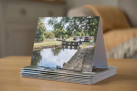 photo cards leeds – a stack of folded greetings cards with a photograph of the Leeds and Liverpool Canal at Rodley on the front, one propped open