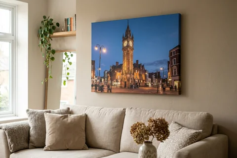 canvas print leicester – a gallery-wrapped canvas print of the Clock Tower at dusk hung above a sofa