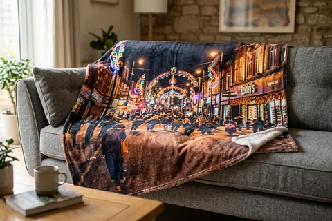 photo blanket leicester – a plush blanket printed edge to edge with the Golden Mile lit for Diwali draped over a sofa