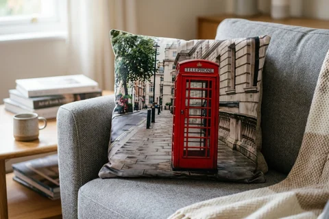 photo cushion london – a plush square cushion printed borderless with a red telephone box on a grey sofa
