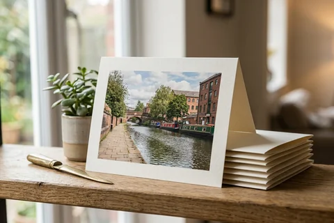 photo cards manchester – a stack of folded greetings cards with a photograph of the Bridgewater Canal on the front, one propped open