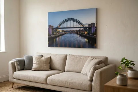canvas print newcastle – a gallery-wrapped canvas print of the Tyne Bridge at dusk hung above a sofa