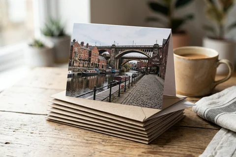 photo cards newcastle – a stack of folded greetings cards with a photograph of the Ouseburn on the front, one propped open