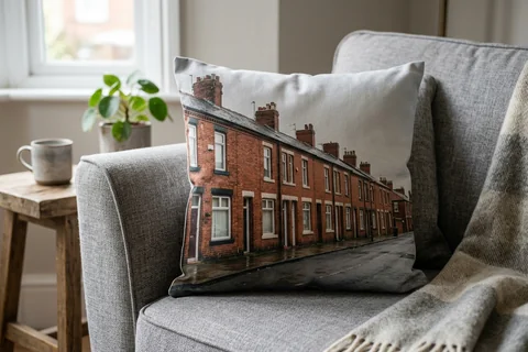 photo cushion newcastle – a plush square cushion printed borderless with a Tyneside flat terrace on a grey sofa