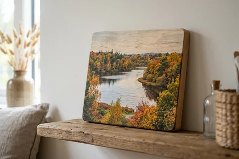 photo print on wood norwich – a wood print of Whitlingham Country Park in autumn with the grain visible through the image, leaning on a shelf