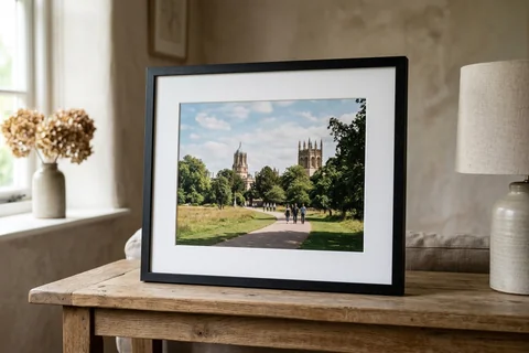 framed photo print oxford – a framed print of Christ Church Meadow with a white mount and black frame standing on a console table