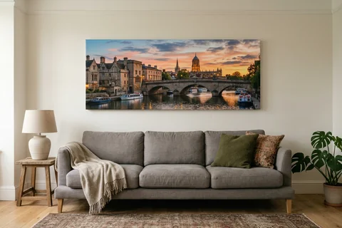 panoramic canvas print oxford – a wide panoramic canvas of the Thames at Folly Bridge at sunset hung above a long sofa