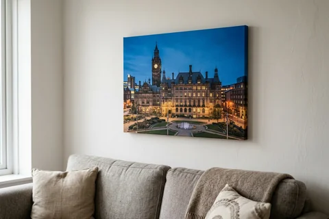 canvas print sheffield – a gallery-wrapped canvas print of Sheffield Town Hall at dusk hung above a sofa
