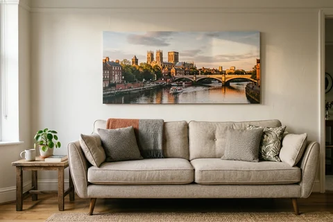 panoramic canvas print york – a wide panoramic canvas of the Ouse from Lendal Bridge at sunset hung above a long sofa