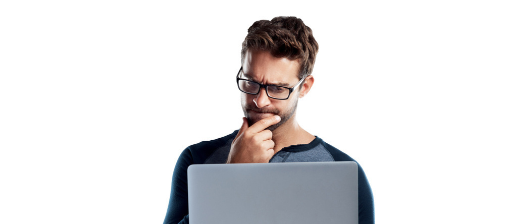 Where to Buy Canvas Prints in the UK. Man looking thoughtfully at laptop.